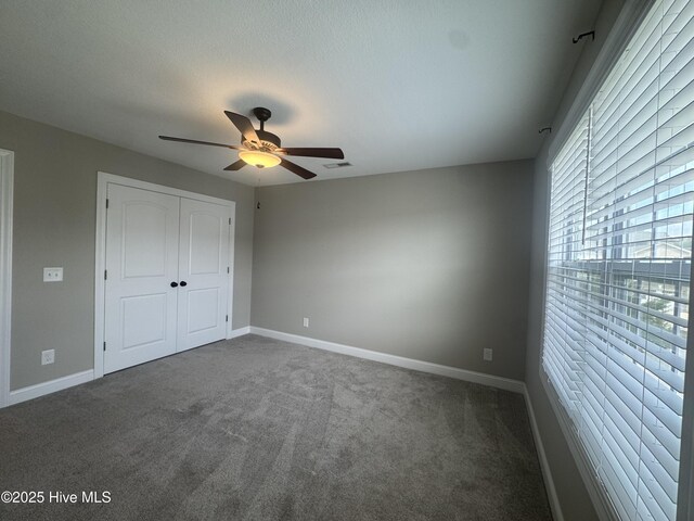 3509 Holman Way Unit B, Greenville, NC 27834 - unfurnished bedroom featuring dark colored carpet, ceiling fan, and a closet
