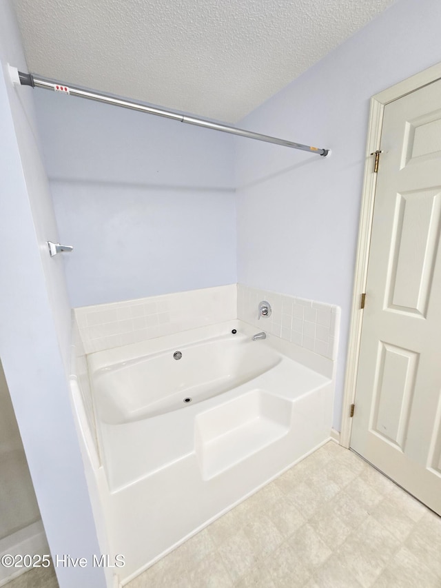 403 Mathew Andrew Ct, Swansboro, NC 28584 - bathroom featuring a garden tub, a textured ceiling, and tile patterned floors