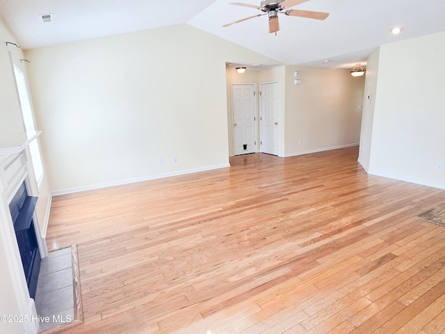 403 Mathew Andrew Ct, Swansboro, NC 28584 - unfurnished living room featuring a ceiling fan, a fireplace, light wood-type flooring, vaulted ceiling, and baseboards