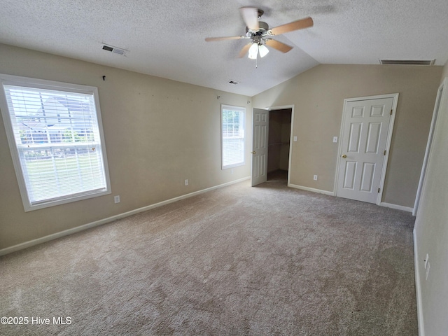 403 Mathew Andrew Ct, Swansboro, NC 28584 - unfurnished bedroom featuring carpet flooring, baseboards, a textured ceiling, vaulted ceiling, and a ceiling fan