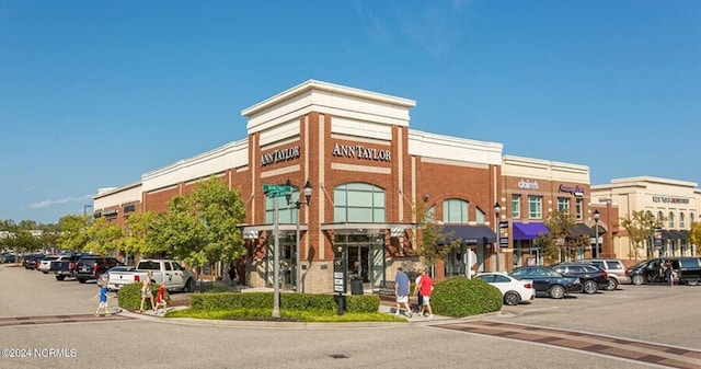 view of commercial property with uncovered parking