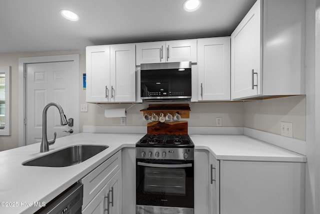 717 Cedar St Unit 1/2, Beaufort, NC 28516 - kitchen with appliances with stainless steel finishes, a sink, white cabinetry, light countertops, and recessed lighting