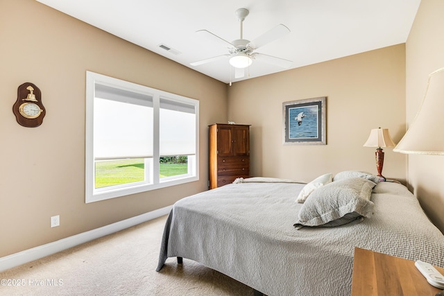 bedroom with light carpet, baseboards, and a ceiling fan