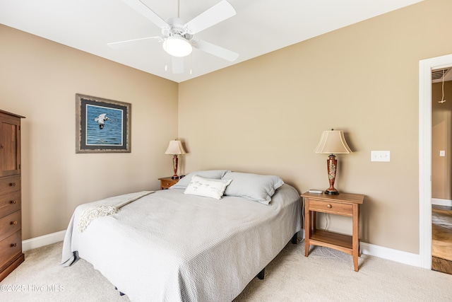 bedroom with light colored carpet, baseboards, and ceiling fan