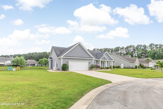 craftsman-style home featuring a garage, a front lawn, concrete driveway, and stone siding