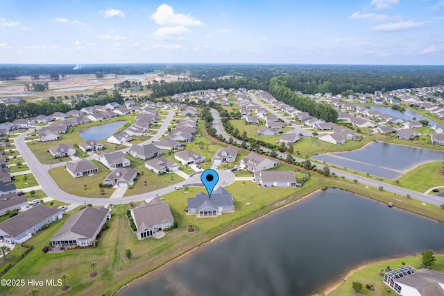 aerial view of property and surrounding area with a nearby body of water and nearby suburban area