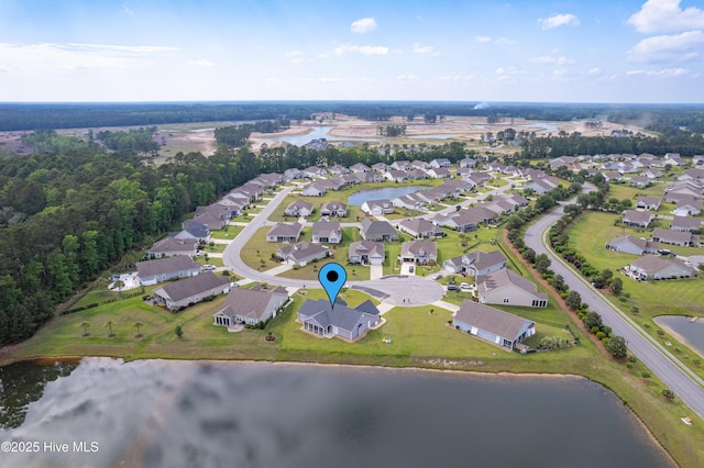 aerial view of property and surrounding area featuring a nearby body of water and nearby suburban area