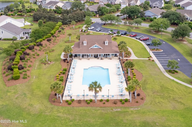aerial perspective of suburban area featuring a pool