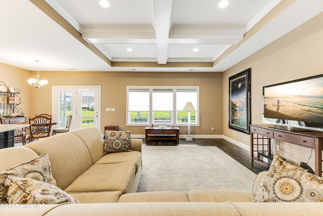 living room featuring coffered ceiling, ornamental molding, beam ceiling, dark wood-type flooring, and a chandelier
