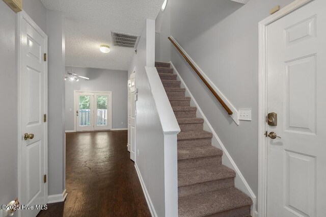 5126 Lamppost Cir, Wilmington, NC 28403 - staircase featuring a textured ceiling, baseboards, wood finished floors, and ceiling fan