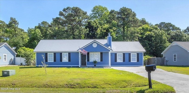 235 Zachary Ln, Hubert, NC 28539 - ranch-style home with a chimney, metal roof, and driveway