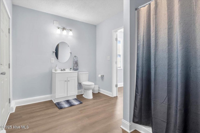 235 Zachary Ln, Hubert, NC 28539 - full bath with wood finished floors, toilet, a textured ceiling, vanity, and baseboards
