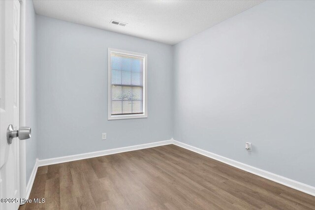 235 Zachary Ln, Hubert, NC 28539 - spare room with dark wood-type flooring, baseboards, and a textured ceiling