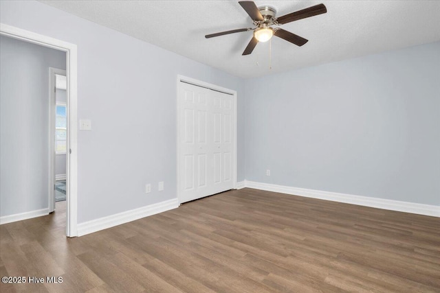 235 Zachary Ln, Hubert, NC 28539 - unfurnished bedroom with dark wood finished floors, a closet, and baseboards