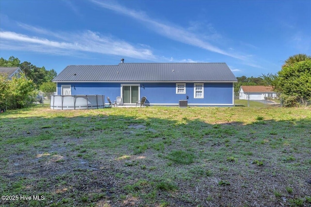 235 Zachary Ln, Hubert, NC 28539 - rear view of house with metal roof and cooling unit