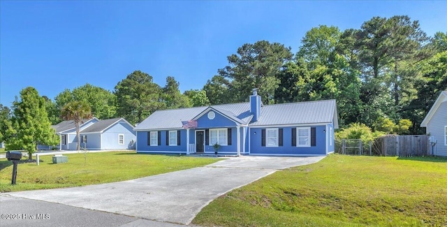 235 Zachary Ln, Hubert, NC 28539 - single story home with driveway, a chimney, and metal roof