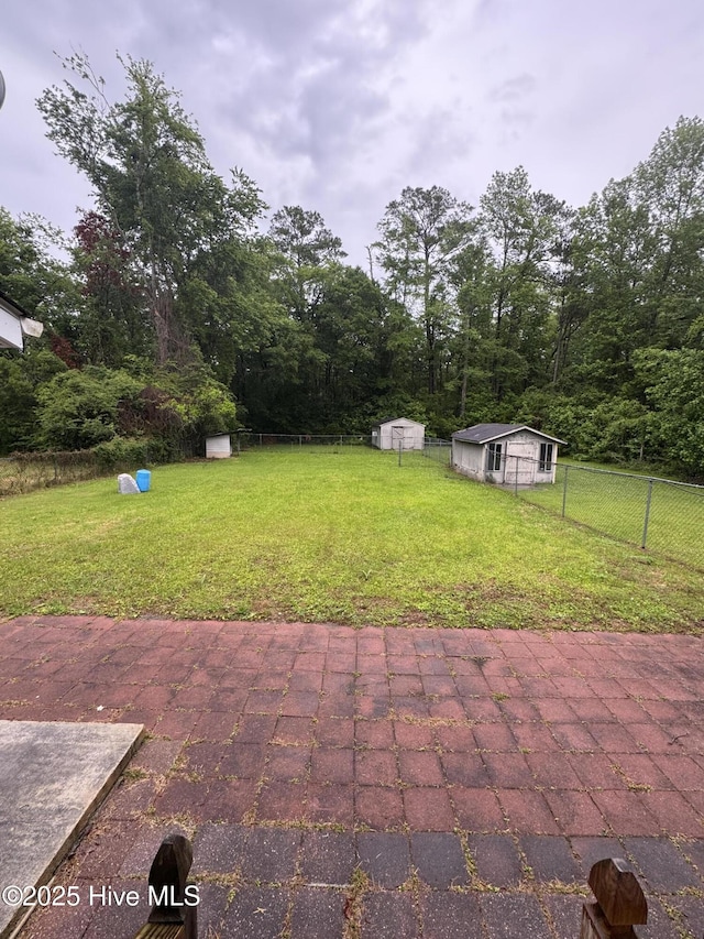 view of patio featuring a shed and an outbuilding