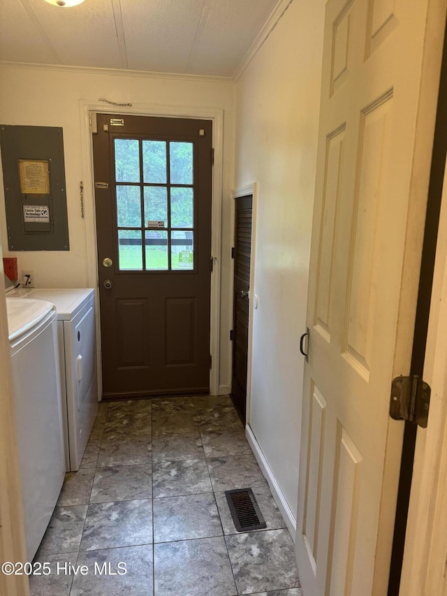 laundry room with washer and clothes dryer, ornamental molding, electric panel, and baseboards