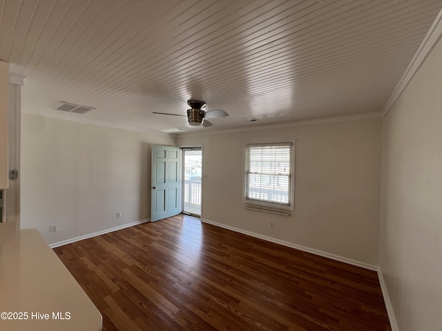 empty room with a ceiling fan, dark wood-style flooring, ornamental molding, baseboards, and wooden ceiling