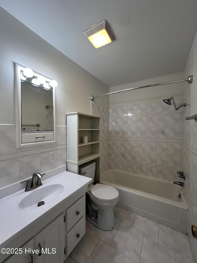 bathroom featuring tile patterned floors, shower / tub combination, toilet, and vanity
