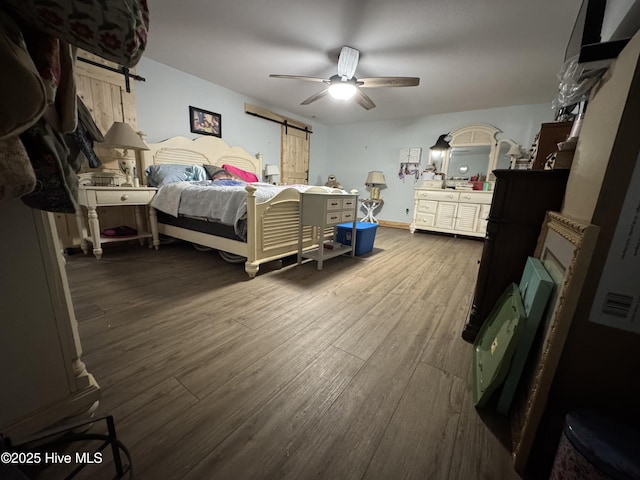200 Wintergreen Patch Ln, Burnsville, NC 28714 - bedroom featuring a barn door, dark wood-style floors, a ceiling fan, and baseboards