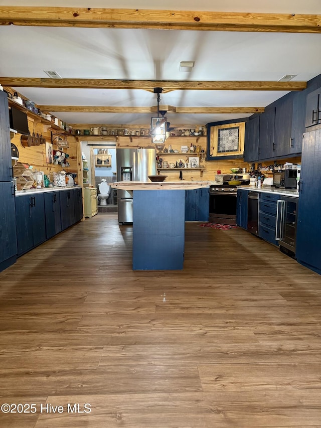 200 Wintergreen Patch Ln, Burnsville, NC 28714 - kitchen featuring stainless steel appliances, light countertops, beam ceiling, wood finished floors, and a peninsula