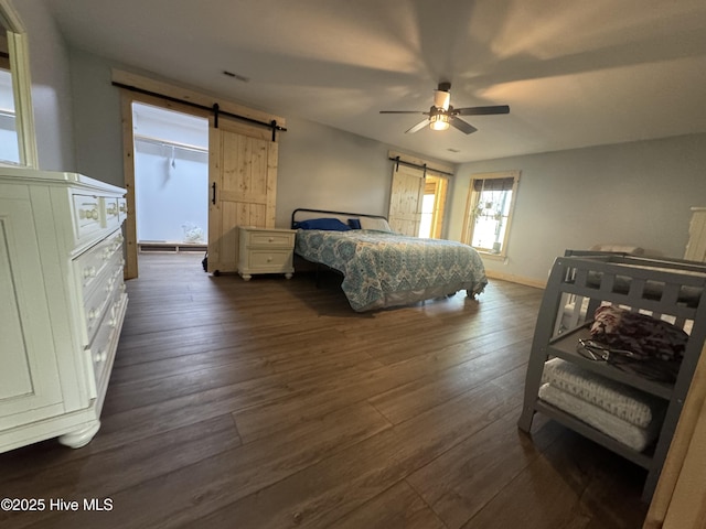 200 Wintergreen Patch Ln, Burnsville, NC 28714 - bedroom featuring a barn door, dark wood-style flooring, and a ceiling fan