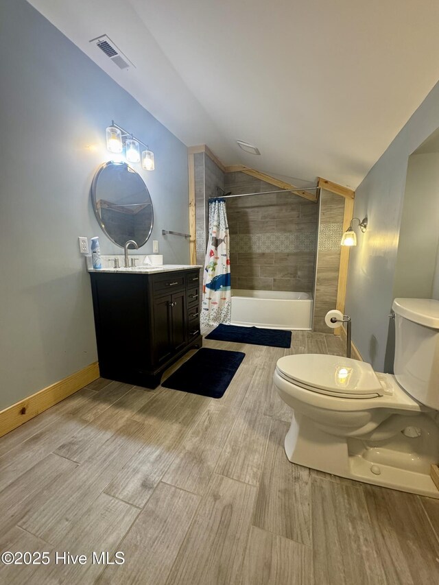 200 Wintergreen Patch Ln, Burnsville, NC 28714 - full bathroom featuring lofted ceiling, toilet, vanity, wood finished floors, and tiled shower / bath combo
