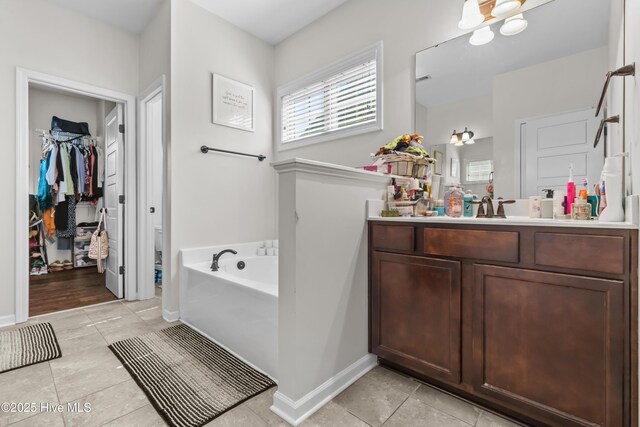 203 Holmes Point Ct, Jacksonville, NC 28546 - full bath featuring tile patterned floors, vanity, a garden tub, and baseboards