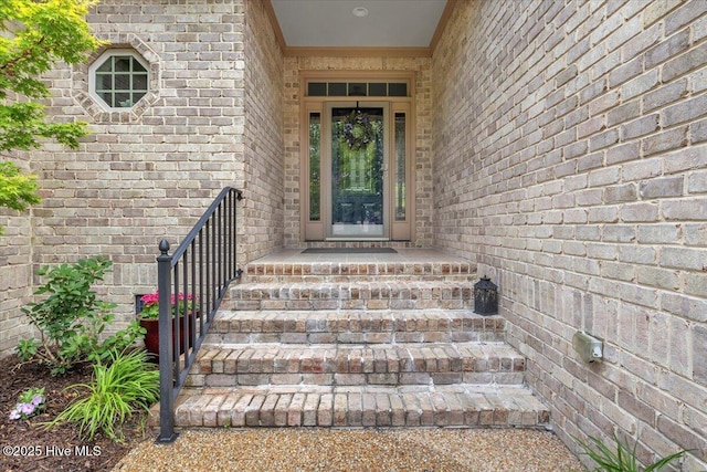 entrance to property featuring brick siding