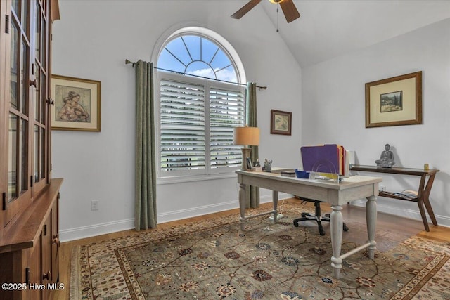 office with ceiling fan, lofted ceiling, wood finished floors, and baseboards