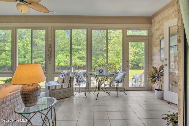 sunroom / solarium featuring crown molding and tile patterned flooring