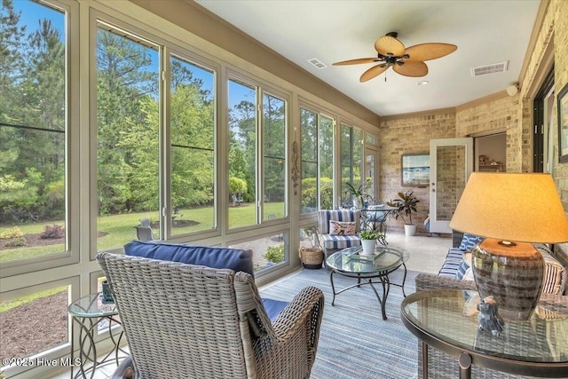 sunroom / solarium featuring ceiling fan