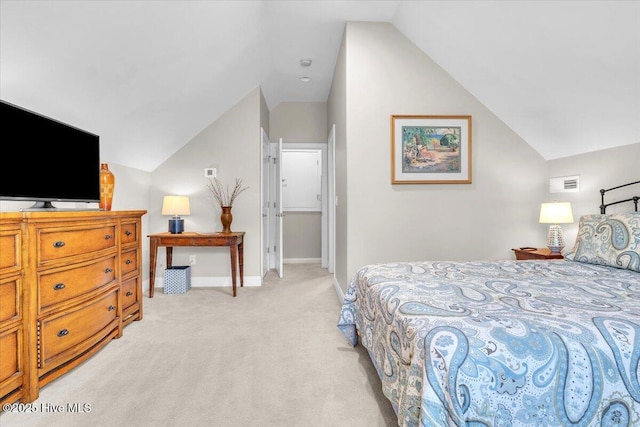 bedroom featuring lofted ceiling, light colored carpet, and baseboards
