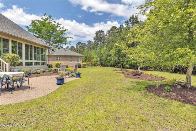 view of grassy yard featuring a patio