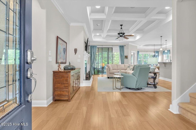 living room featuring baseboards, a ceiling fan, light wood finished floors, beamed ceiling, and coffered ceiling