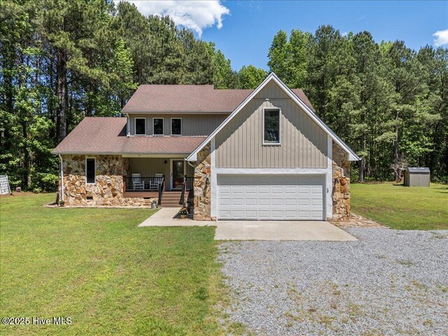 476 Paige Riddick Rd, Gates, NC 27937 - view of front of house with stone siding, gravel driveway, a porch, and a front yard