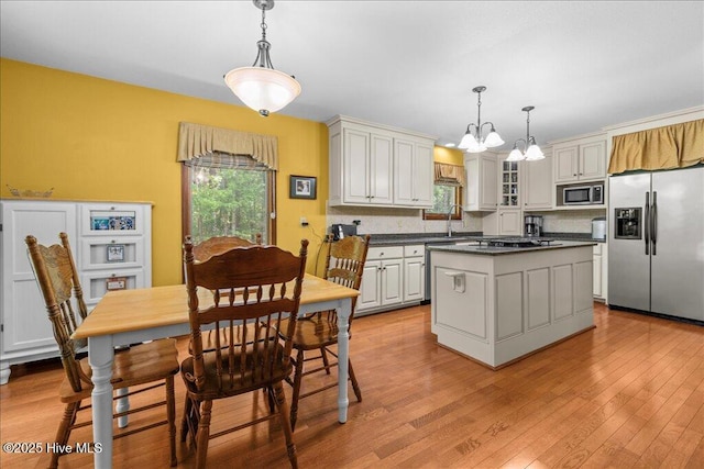 476 Paige Riddick Rd, Gates, NC 27937 - kitchen with appliances with stainless steel finishes, dark countertops, a chandelier, and healthy amount of natural light
