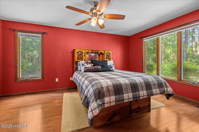 476 Paige Riddick Rd, Gates, NC 27937 - bedroom featuring hardwood / wood-style flooring, baseboards, and a ceiling fan