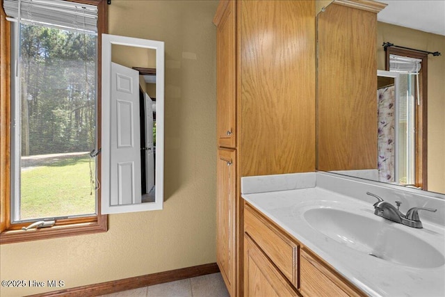 476 Paige Riddick Rd, Gates, NC 27937 - bathroom featuring baseboards, tile patterned floors, and vanity