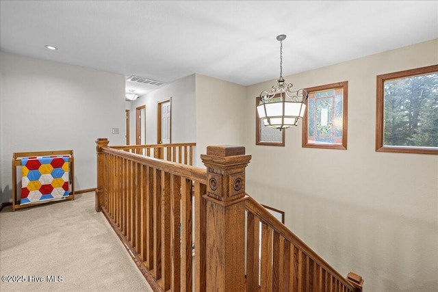 476 Paige Riddick Rd, Gates, NC 27937 - hall featuring an upstairs landing, a chandelier, light carpet, and baseboards
