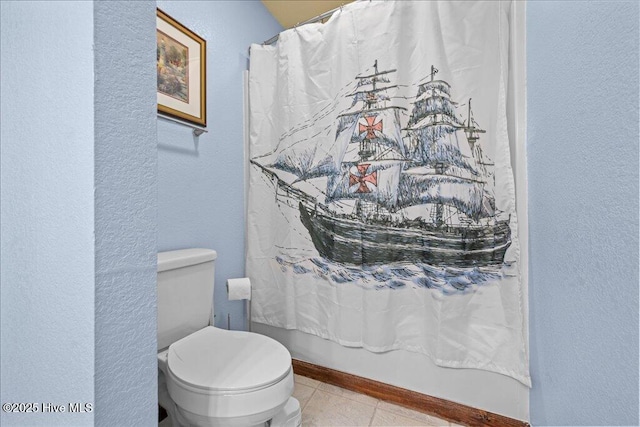476 Paige Riddick Rd, Gates, NC 27937 - bathroom with a textured wall, tile patterned floors, and toilet