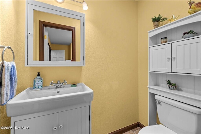 476 Paige Riddick Rd, Gates, NC 27937 - bathroom featuring toilet, a textured wall, and vanity