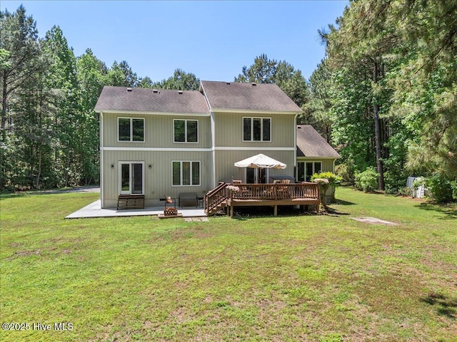 476 Paige Riddick Rd, Gates, NC 27937 - rear view of property with a patio area, a wooden deck, an outdoor fire pit, and a lawn