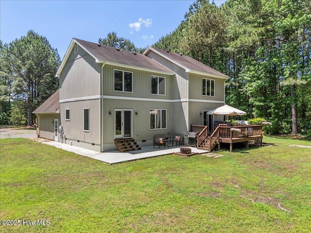 476 Paige Riddick Rd, Gates, NC 27937 - rear view of house with a wooden deck, a patio area, a yard, entry steps, and a fire pit