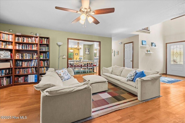 476 Paige Riddick Rd, Gates, NC 27937 - living area featuring wood finished floors, a ceiling fan, and a chandelier