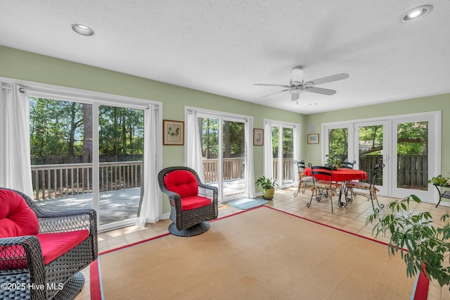 sunroom / solarium featuring french doors