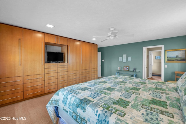 bedroom featuring light colored carpet, a ceiling fan, and recessed lighting