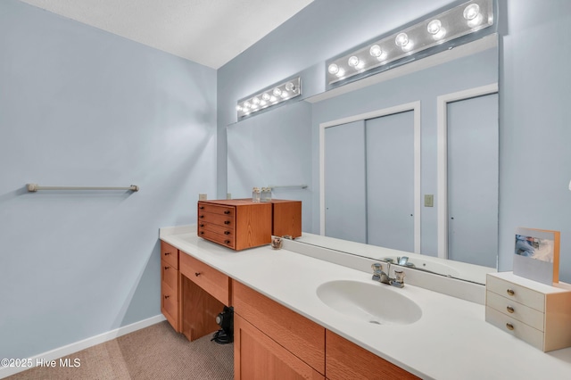 bathroom featuring baseboards and vanity