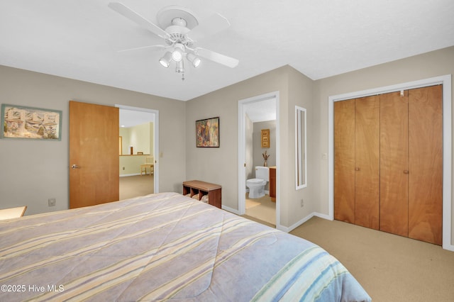 bedroom with carpet, a closet, connected bathroom, a ceiling fan, and baseboards